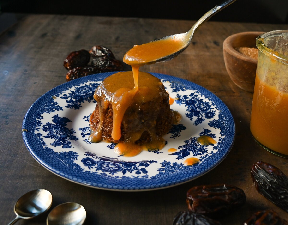 Sticky Toffee Pudding. A famous English dessert with a moist sponge cake covered in homemade caramel toffee sauce and vanilla ice cream. This is a beautiful Christmas dessert recipe.