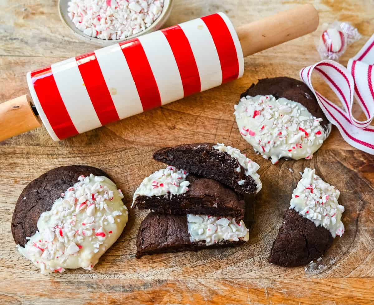 White Chocolate Dipped Peppermint Chocolate Cookies. The Double Chocolate Peppermint Cookies are soft baked, rich double chocolate brownie cookies dipped in white chocolate and covered with peppermint candy canes. The perfect Christmas holiday cookie recipe.
