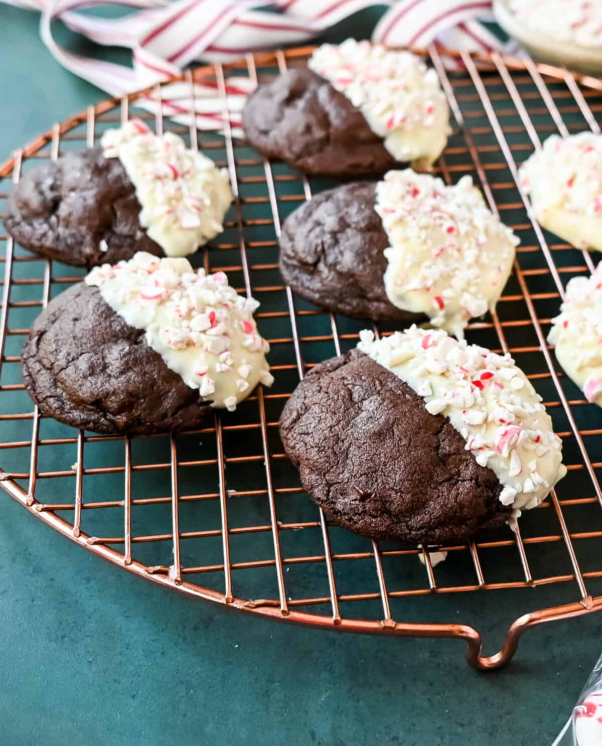 White Chocolate Dipped Peppermint Chocolate Cookies. The Double Chocolate Peppermint Cookies are soft baked, rich double chocolate brownie cookies dipped in white chocolate and covered with peppermint candy canes. The perfect Christmas holiday cookie recipe.