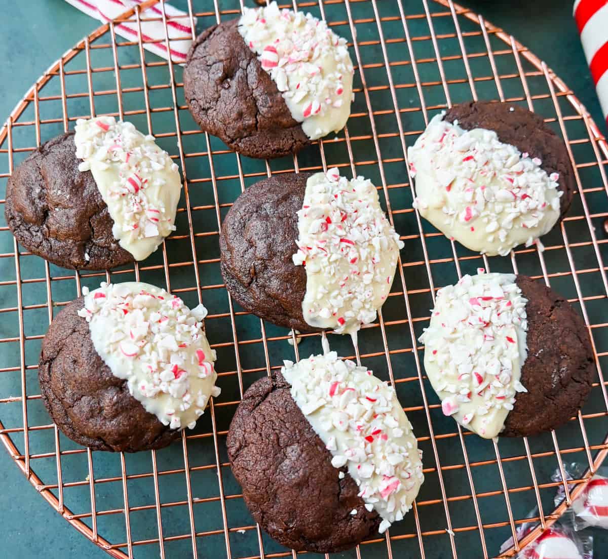 White Chocolate Dipped Peppermint Chocolate Cookies. The Double Chocolate Peppermint Cookies are soft baked, rich double chocolate brownie cookies dipped in white chocolate and covered with peppermint candy canes. The perfect Christmas holiday cookie recipe.