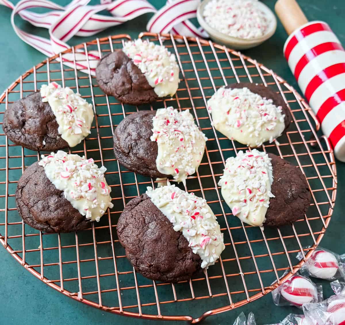 White Chocolate Dipped Peppermint Chocolate Cookies. The Double Chocolate Peppermint Cookies are soft baked, rich double chocolate brownie cookies dipped in white chocolate and covered with peppermint candy canes. The perfect Christmas holiday cookie recipe.