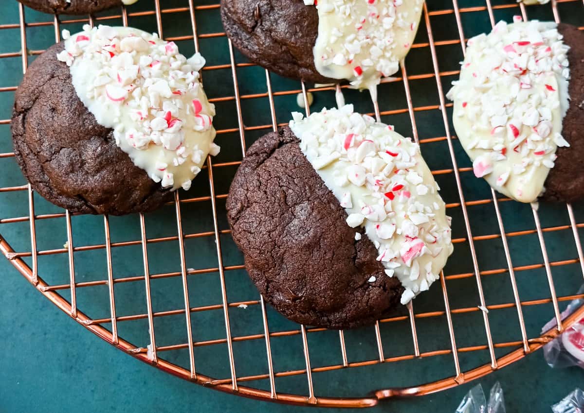 White Chocolate Dipped Peppermint Chocolate Cookies. The Double Chocolate Peppermint Cookies are soft baked, rich double chocolate brownie cookies dipped in white chocolate and covered with peppermint candy canes. The perfect Christmas holiday cookie recipe.