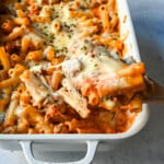This Baked Ziti Pasta is made with ziti noodles, sausage, marinara sauce, fresh basil, spices, whole milk mozzarella cheese, parmesan cheese, and heavy cream and baked until the cheese is melted. The best-baked ziti recipe! This is a perfect recipe to freeze or make ahead of time.
