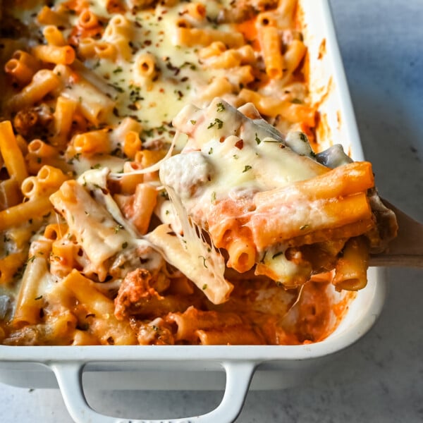 This Baked Ziti Pasta is made with ziti noodles, sausage, marinara sauce, fresh basil, spices, whole milk mozzarella cheese, parmesan cheese, and heavy cream and baked until the cheese is melted. The best-baked ziti recipe! This is a perfect recipe to freeze or make ahead of time.