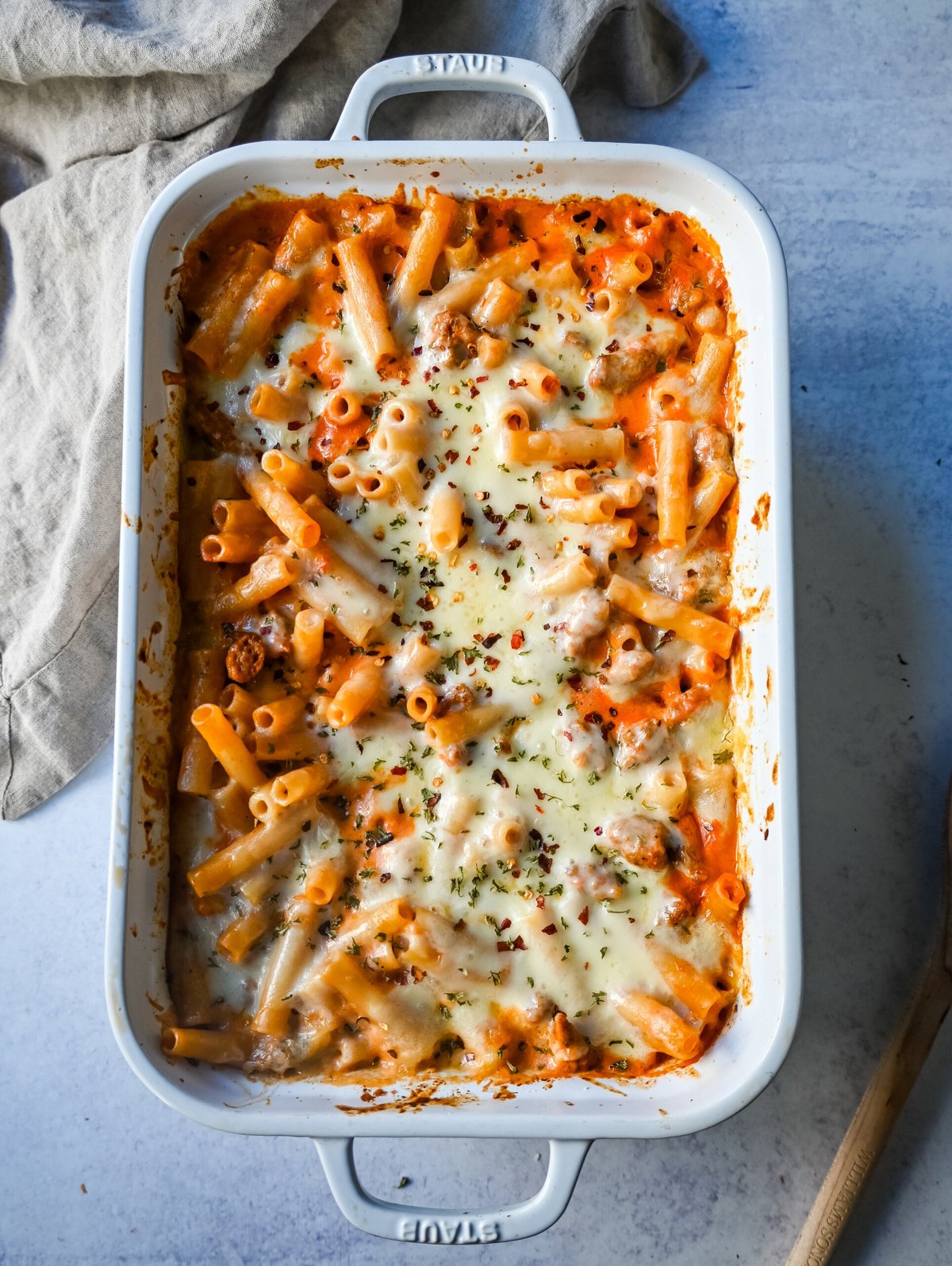 This Baked Ziti Pasta is made with ziti noodles, sausage, marinara sauce, fresh basil, spices, whole milk mozzarella cheese, parmesan cheese, and heavy cream and baked until the cheese is melted. The best-baked ziti recipe! This is a perfect recipe to freeze or make ahead of time.