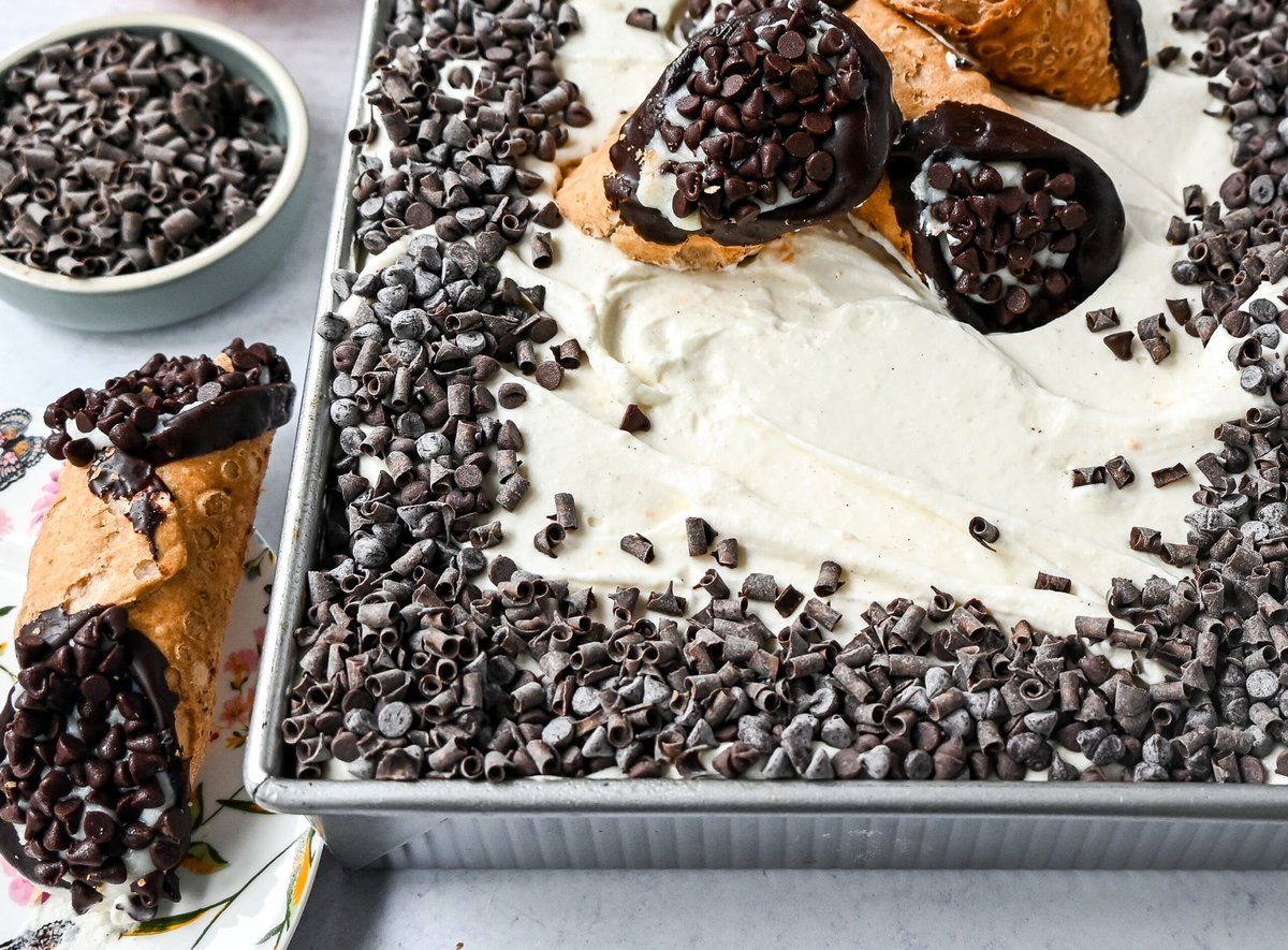 Cannoli Sheet Cake. A light and fluffy yellow chocolate chip cake topped with a sweet ricotta cream topping and mini chocolate chips. All of the flavor of a cannoli in a delicious cake.