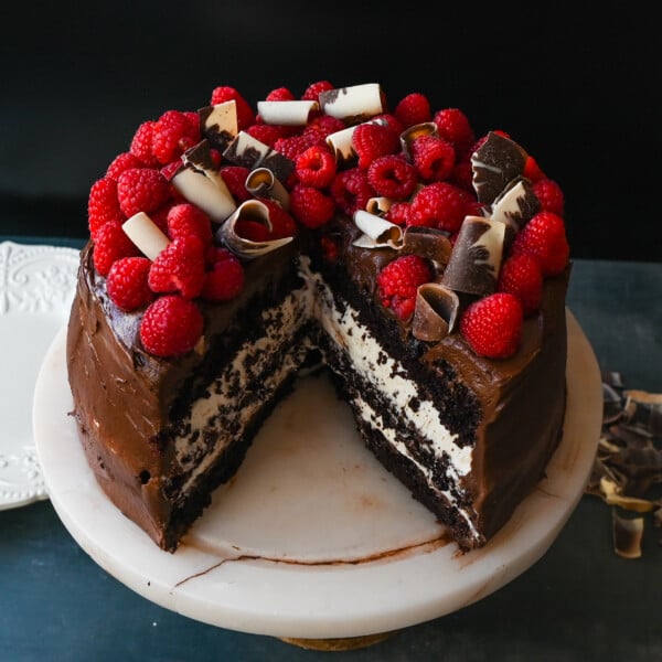 This is the Best Chocolate Raspberry Cake Recipe. Rich layered chocolate cake with whipped cream cheese raspberry filling, topped with creamy chocolate buttercream frosting and fresh raspberries. 