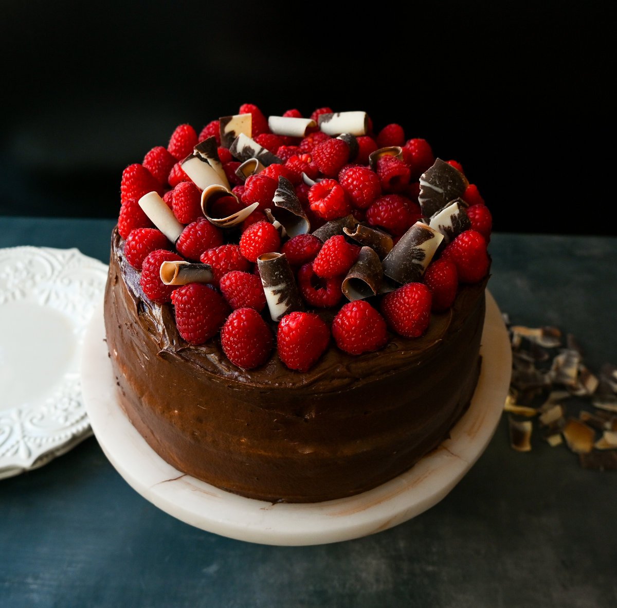 This is the Best Chocolate Raspberry Cake Recipe. Rich layered chocolate cake with whipped cream cheese raspberry filling, topped with creamy chocolate buttercream frosting and fresh raspberries. 