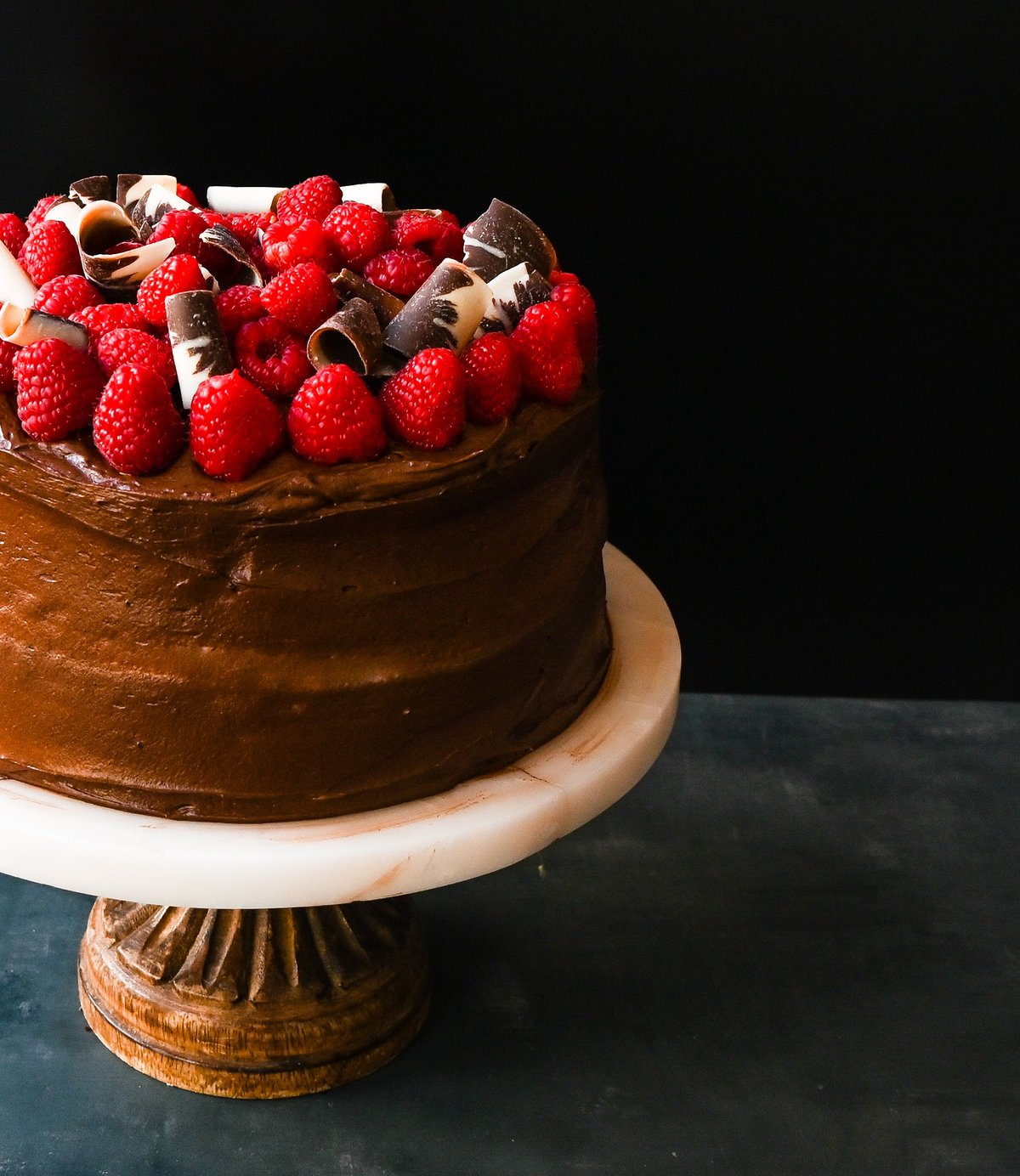 This is the Best Chocolate Raspberry Cake Recipe. Rich layered chocolate cake with whipped cream cheese raspberry filling, topped with creamy chocolate buttercream frosting and fresh raspberries. 