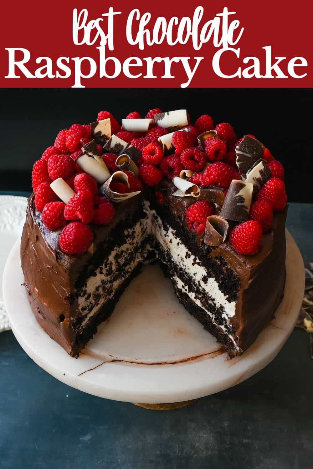 This is the Best Chocolate Raspberry Cake Recipe. Rich layered chocolate cake with whipped cream cheese raspberry filling, topped with creamy chocolate buttercream frosting and fresh raspberries. 