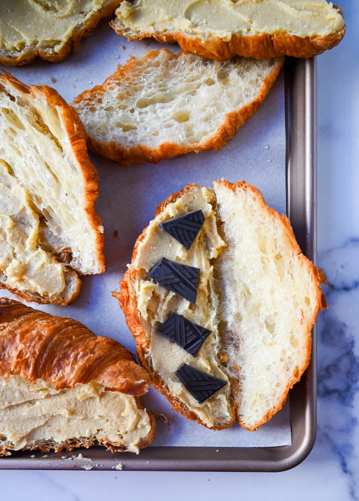 Chocolate and almond filling spread on croissant before baking