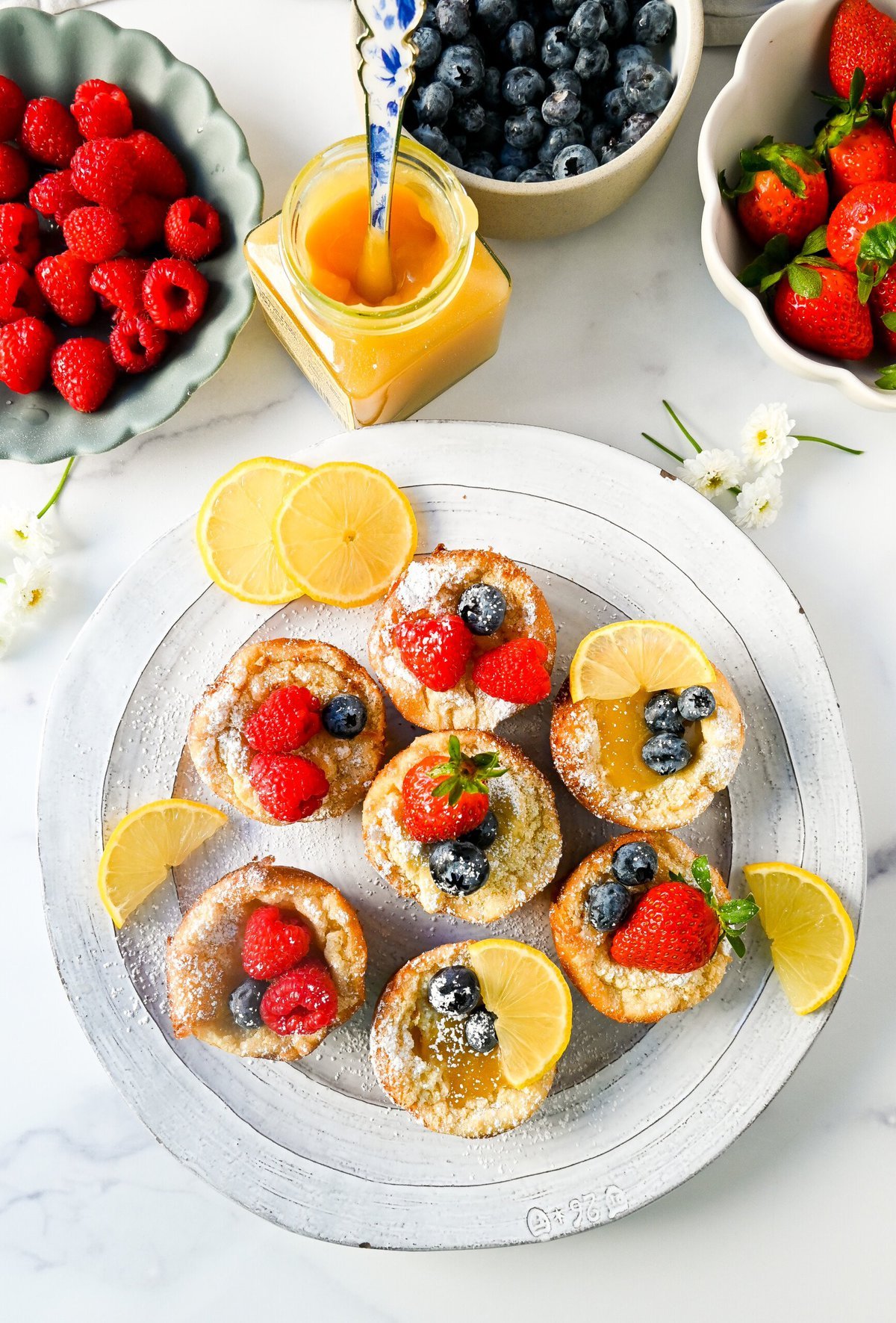 Mini Dutch Baby Pancakes (in a muffin tin). These mini, bite-size Dutch Baby pancakes are made the same way as traditional German pancakes but these are baked in muffin tins. These easy, golden and buttery mini puffed pancakes are perfect to serve to family and friends.