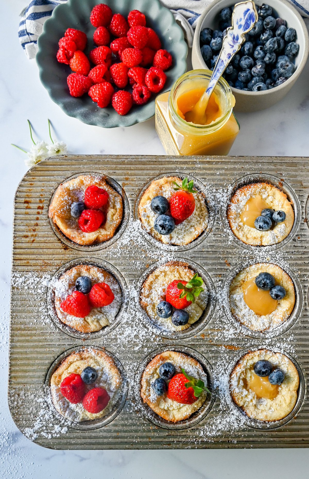 Mini Dutch Baby Pancakes (in a muffin tin). These mini, bite-size Dutch Baby pancakes are made the same way as traditional German pancakes but these are baked in muffin tins. These easy, golden and buttery mini puffed pancakes are perfect to serve to family and friends.
