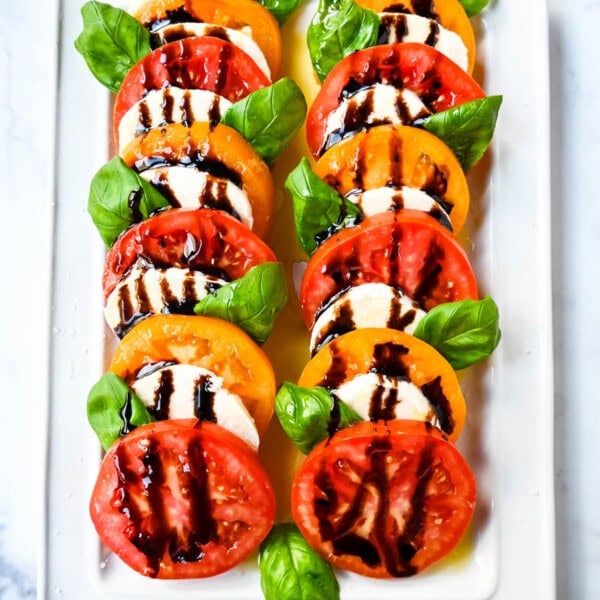 This caprese salad is the ultimate fresh summer dish, made with juicy, colorful heirloom tomatoes, creamy mozzarella, balsamic glaze and fragrant basil. If you’re looking for a fresh tomato salad recipe that’s both beautiful and delicious, this is it.