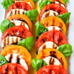 This caprese salad is the ultimate fresh summer dish, made with juicy, colorful heirloom tomatoes, creamy mozzarella, balsamic glaze and fragrant basil. If you’re looking for a fresh tomato salad recipe that’s both beautiful and delicious, this is it.