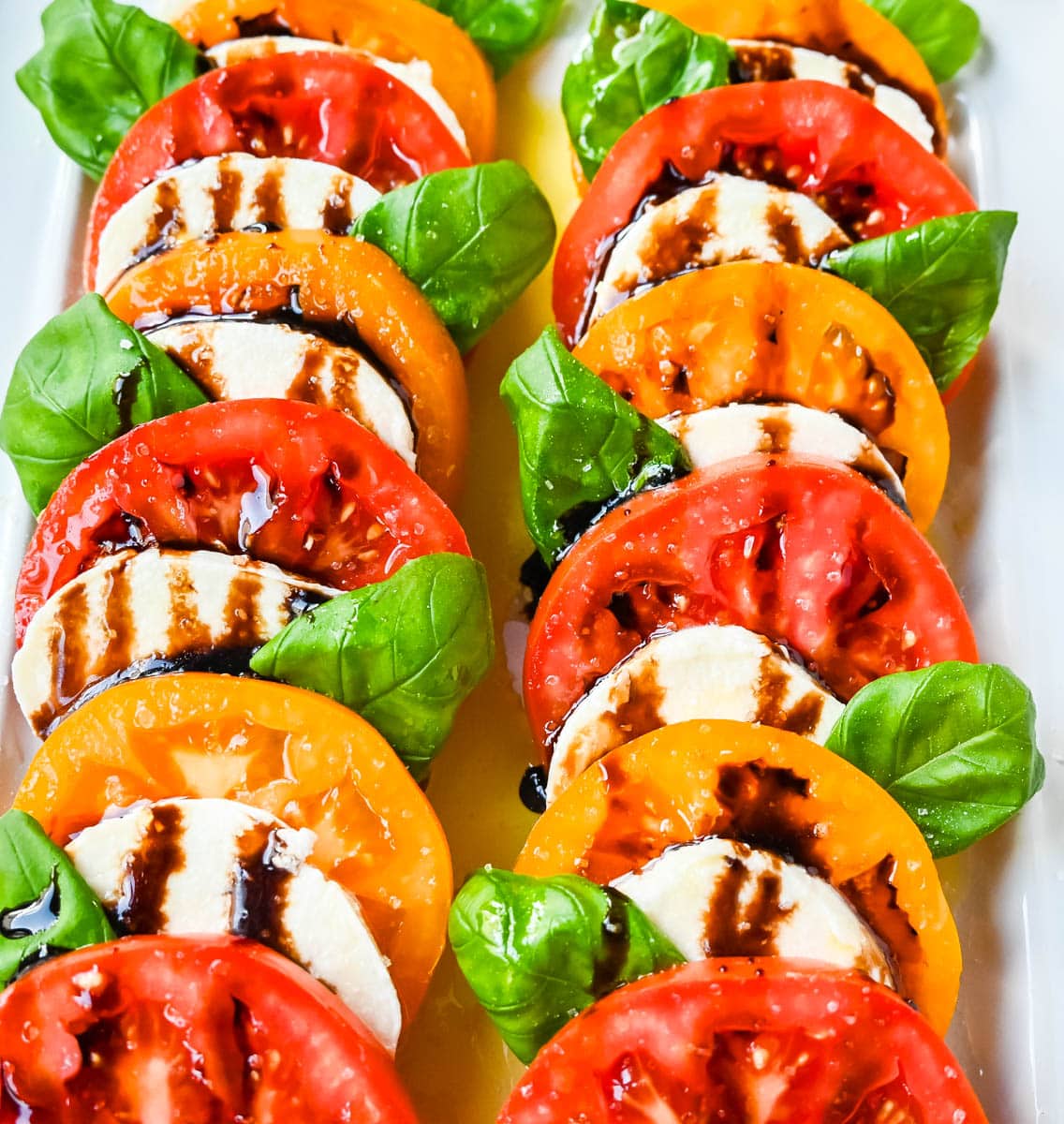 This caprese salad is the ultimate fresh summer dish, made with juicy, colorful heirloom tomatoes, creamy mozzarella, balsamic glaze and fragrant basil. If you’re looking for a fresh tomato salad recipe that’s both beautiful and delicious, this is it.