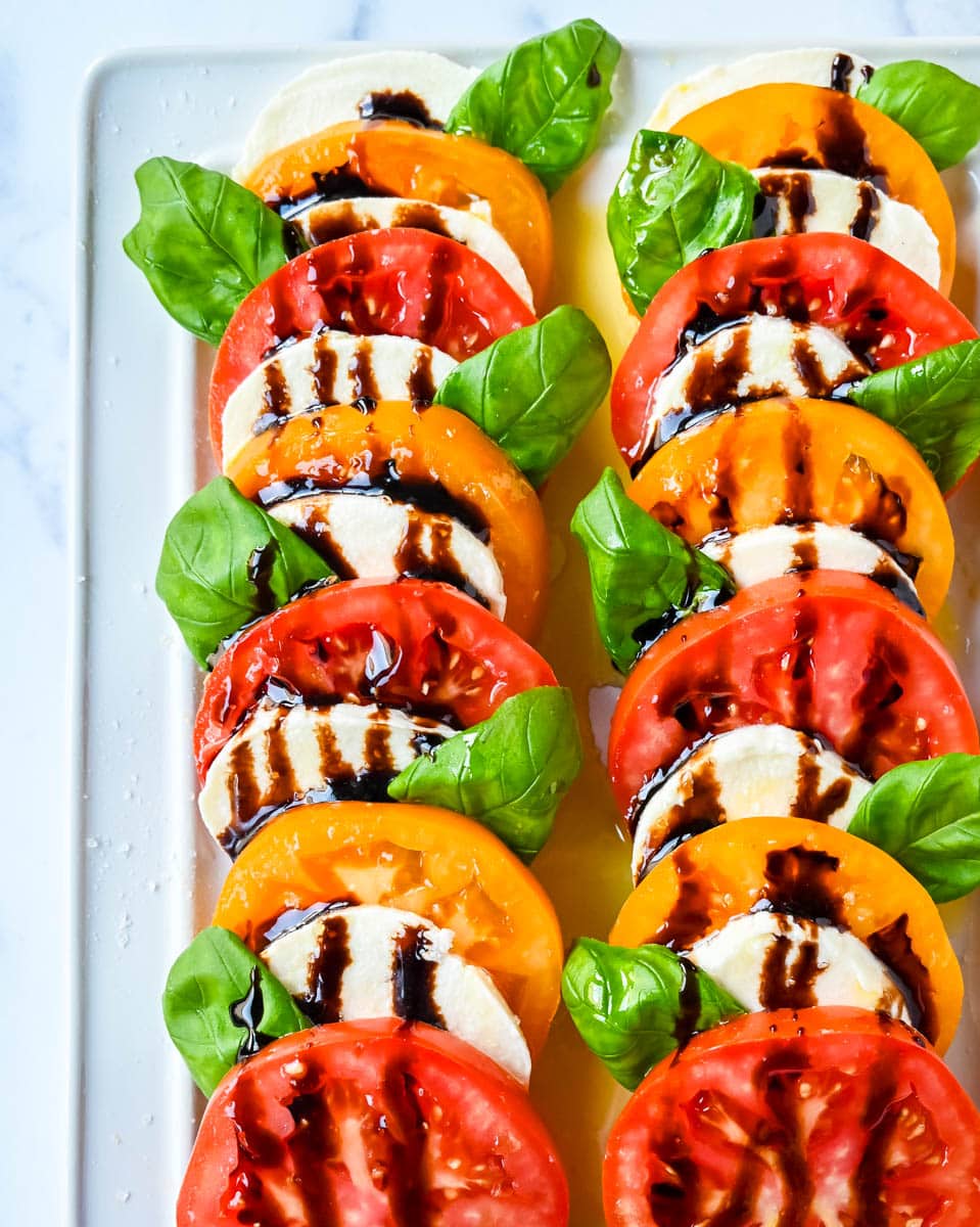 This caprese salad is the ultimate fresh summer dish, made with juicy, colorful heirloom tomatoes, creamy mozzarella, balsamic glaze and fragrant basil. If you’re looking for a fresh tomato salad recipe that’s both beautiful and delicious, this is it.