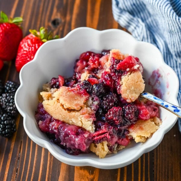 This homemade Berry Crisp is made with fresh Raspberries, Blackberries, Strawberries, and Blueberries and topped with a buttery sugar cookie crumble topping. This berry crumble is the perfect summer dessert.