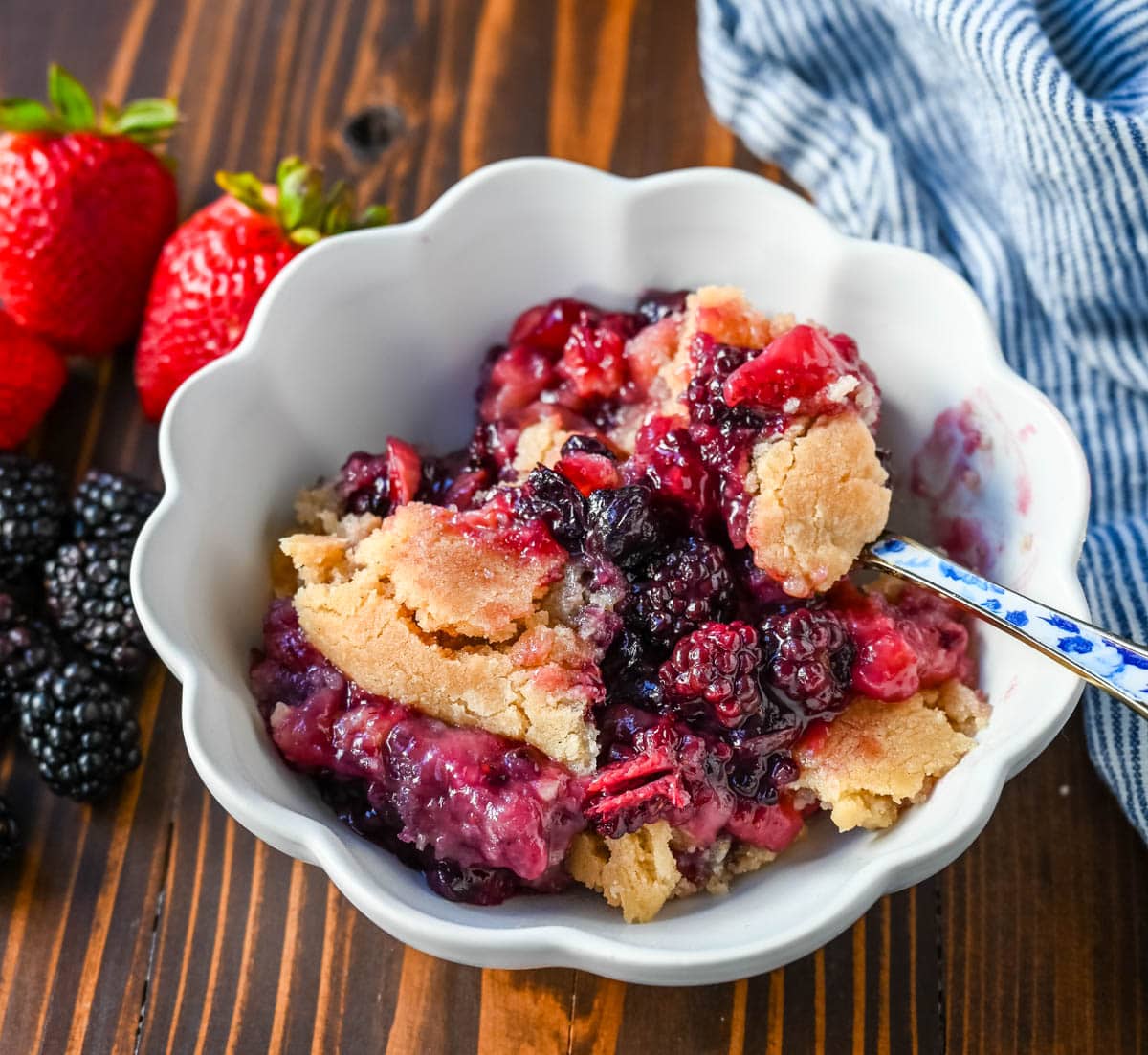 This homemade Berry Crisp is made with fresh Raspberries, Blackberries, Strawberries, and Blueberries and topped with a buttery sugar cookie crumble topping. This berry crumble is the perfect summer dessert.