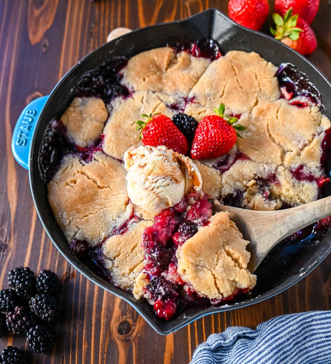 This homemade Berry Crisp is made with fresh Raspberries, Blackberries, Strawberries, and Blueberries and topped with a buttery sugar cookie crumble topping. This berry crumble is the perfect summer dessert.