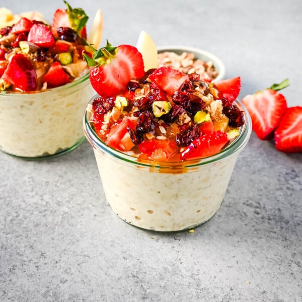 This overnight oats recipe also called Bircher Muesli is made by soaking oats overnight with juice, milk, honey, vanilla, and greek yogurt and then fold in vanilla whipped cream for extra creaminess and topped with fresh fruits, dried fruits, and nuts. It is the perfect and delicious easy, grab-and-go breakfast.