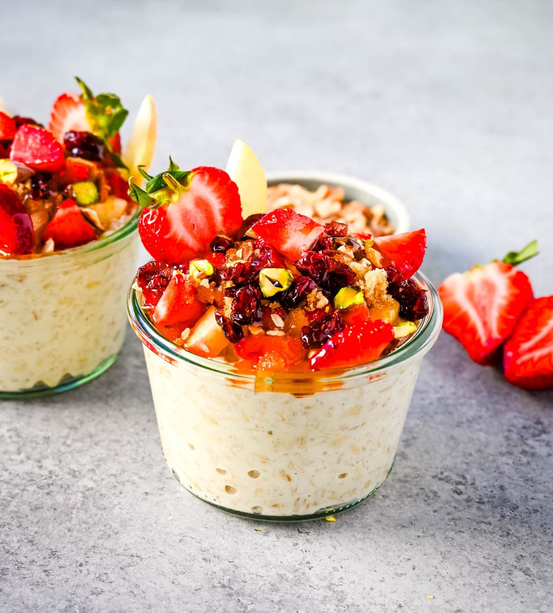 This overnight oats recipe also called Bircher Muesli is made by soaking oats overnight with juice, milk, honey, vanilla, and greek yogurt and then fold in vanilla whipped cream for extra creaminess and topped with fresh fruits, dried fruits, and nuts. It is the perfect and delicious easy, grab-and-go breakfast.