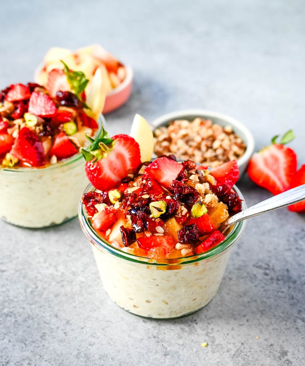 This overnight oats recipe also called Bircher Muesli is made by soaking oats overnight with juice, milk, honey, vanilla, and greek yogurt and then fold in vanilla whipped cream for extra creaminess and topped with fresh fruits, dried fruits, and nuts. It is the perfect and delicious easy, grab-and-go breakfast.