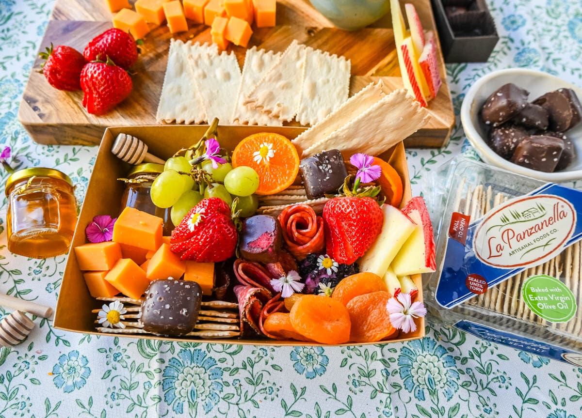 Charcuterie boards have become the epitome of gourmet snacking. But what if you are craving a charcuterie board but you want it on a smaller scale? Enter the mini charcuterie box – a perfect personal-sized grazing box that packs all the flavor in a small package. 