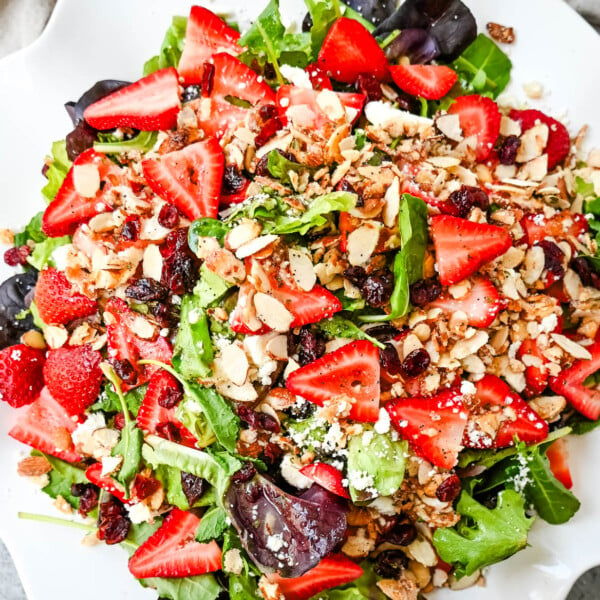 Strawberry Spring Mix Salad. This Strawberry Poppyseed Salad is made with spring mix, fresh strawberries, creamy and tangy feta cheese, sugared almonds, and tossed with a sweet homemade poppyseed dressing.