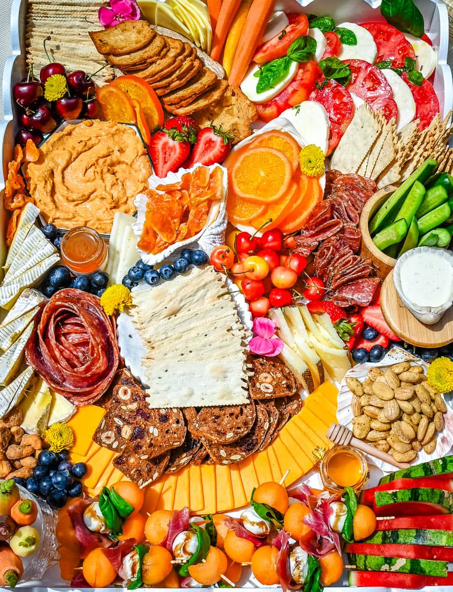 How to make an epic, beautiful Summer Charcuterie Board highlighting all of the fresh fruits and vegetables in season, paired with cheeses and meats perfect for summer. I am sharing all of the ideas on how to create the perfect charcuterie board for summer.