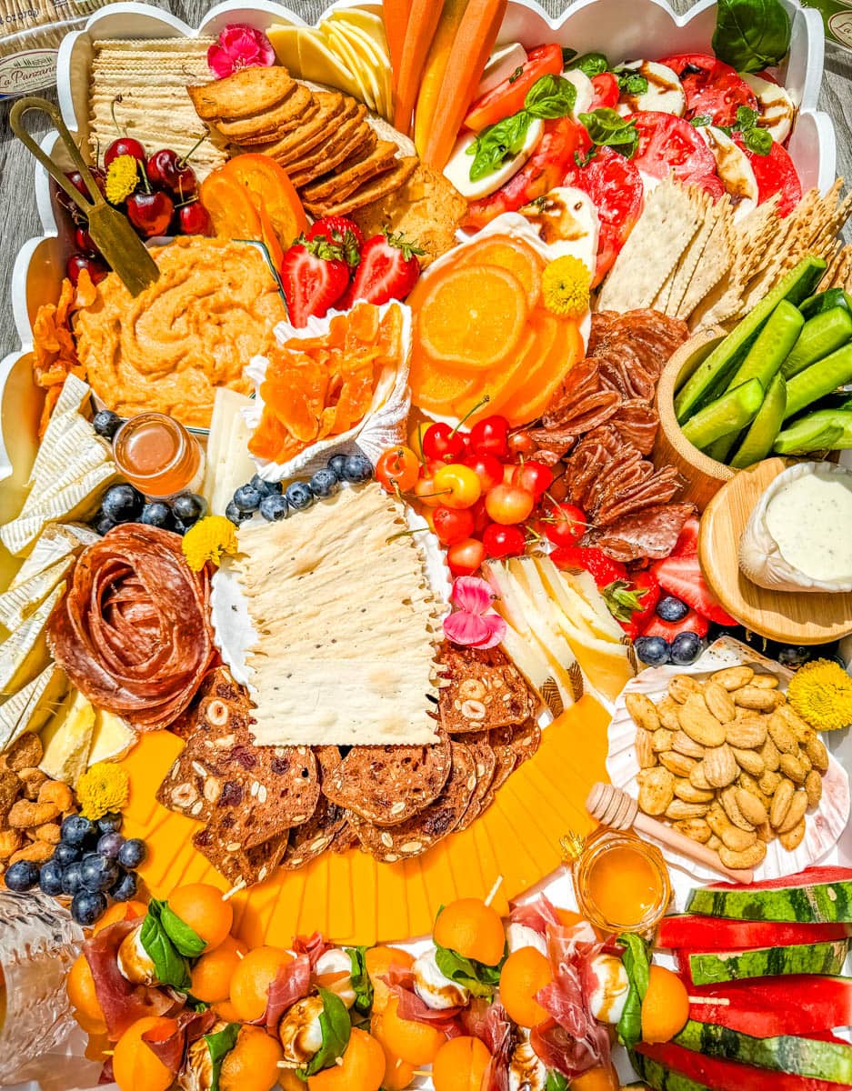 How to make an epic, beautiful Summer Charcuterie Board highlighting all of the fresh fruits and vegetables in season, paired with cheeses and meats perfect for summer. I am sharing all of the ideas on how to create the perfect charcuterie board for summer.