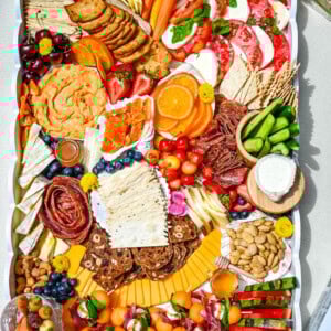 How to make an epic, beautiful Summer Charcuterie Board highlighting all of the fresh fruits and vegetables in season, paired with cheeses and meats perfect for summer. I am sharing all of the ideas on how to create the perfect charcuterie board for summer.