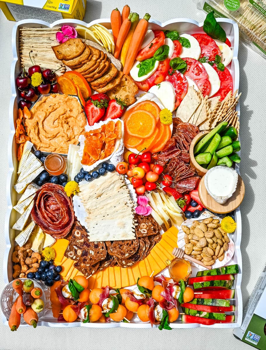 How to make an epic, beautiful Summer Charcuterie Board highlighting all of the fresh fruits and vegetables in season, paired with cheeses and meats perfect for summer. I am sharing all of the ideas on how to create the perfect charcuterie board for summer.
