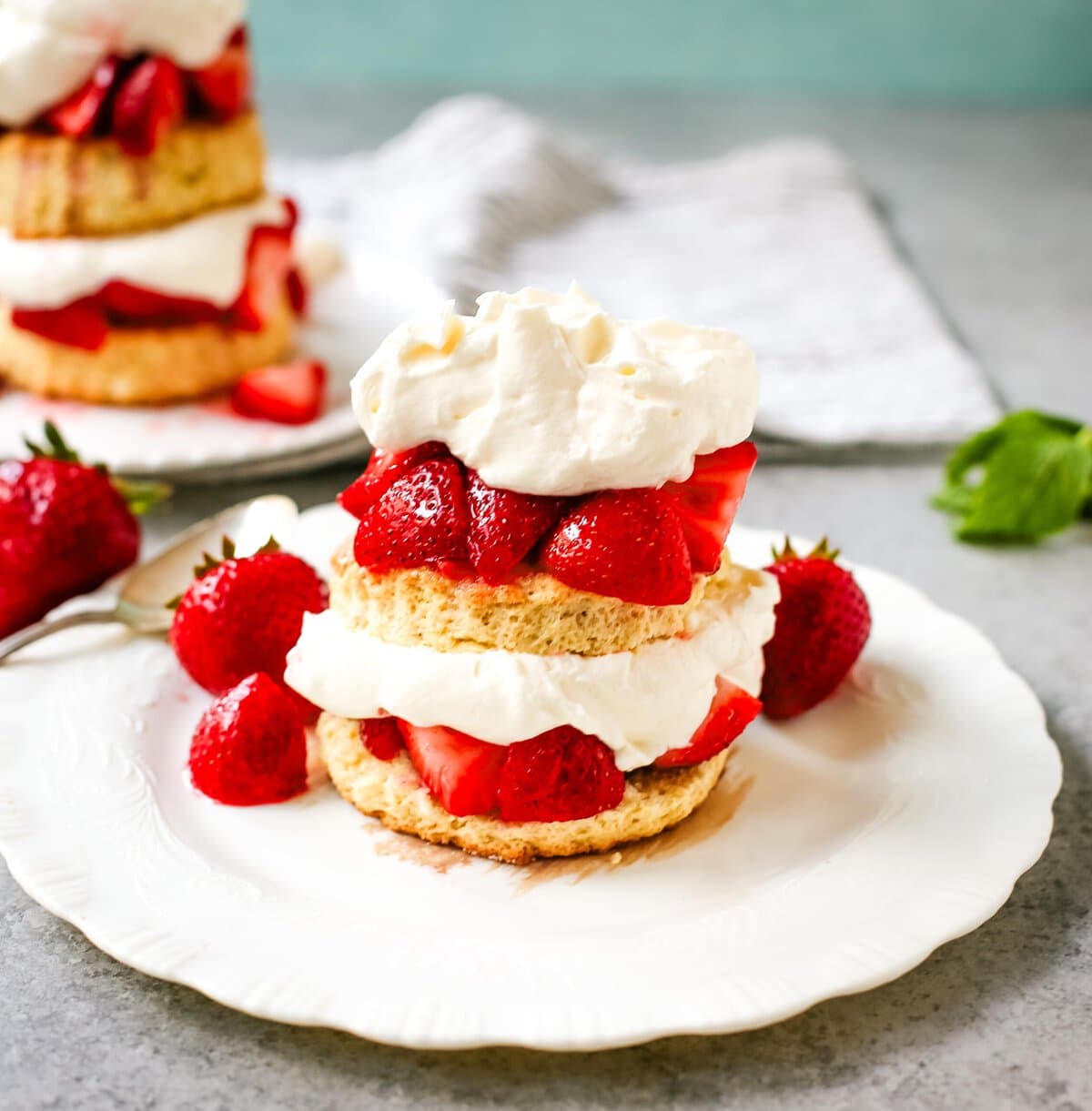 The Best Strawberry Shortcake with Homemade Sweet Biscuits, Sliced Strawberries, and Sweetened Whipped Cream. The sweet biscuits paired with sugared, syrupy strawberries, and fluffy whipped cream.