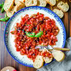 This quick and easy appetizer is made with garlic and herb Boursin cheese and topped with a fresh caprese salad made with tomatoes, olive oil, balsamic glaze, basil, and garlic. This Caprese Dip with boursin cheese pairs perfectly with crostinis or crackers.