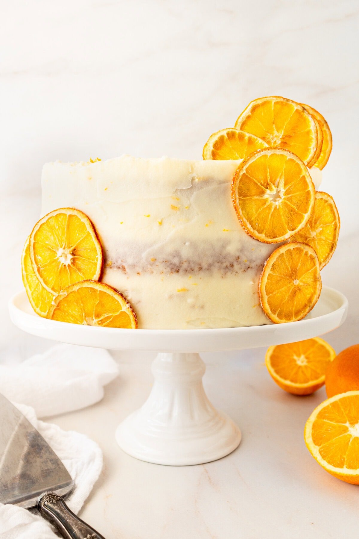 A moist, tender fresh orange cake with a sweet orange cream cheese frosting. This homemade orange cake that is bursting with bright citrus flavor in every bite. Each layer is moist, fluffy, and perfectly enhanced by an orange cream cheese frosting. The fresh orange juice and zest adds fresh orange flavor. Here are tips for making the perfect frosted orange cake! This can also be made into an orange naked cake.