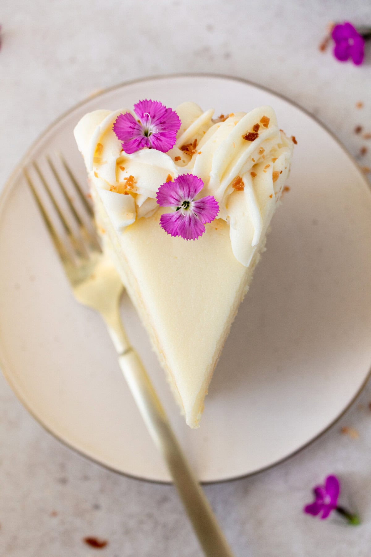 This homemade, moist coconut cake with coconut cream cheese frosting is the best coconut cake recipe. It is made with sweet cream butter, coconut milk, buttermilk, coconut pudding mix, and cake flour to make it extra tender. The coconut cream cheese frosting puts it over the top!