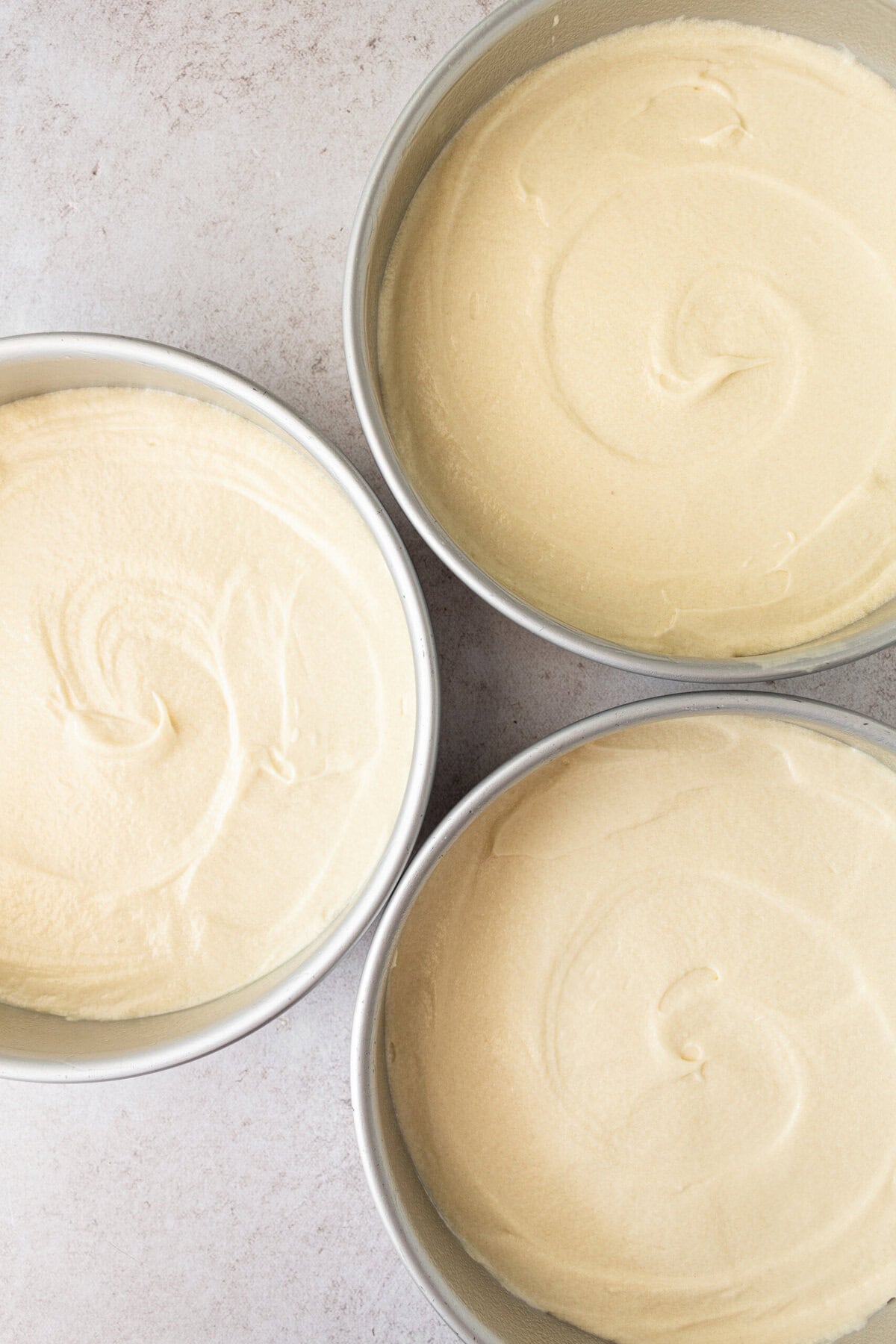 Coconut cake batter in three 8-inch cake pans for a 3-layer coconut cake.
