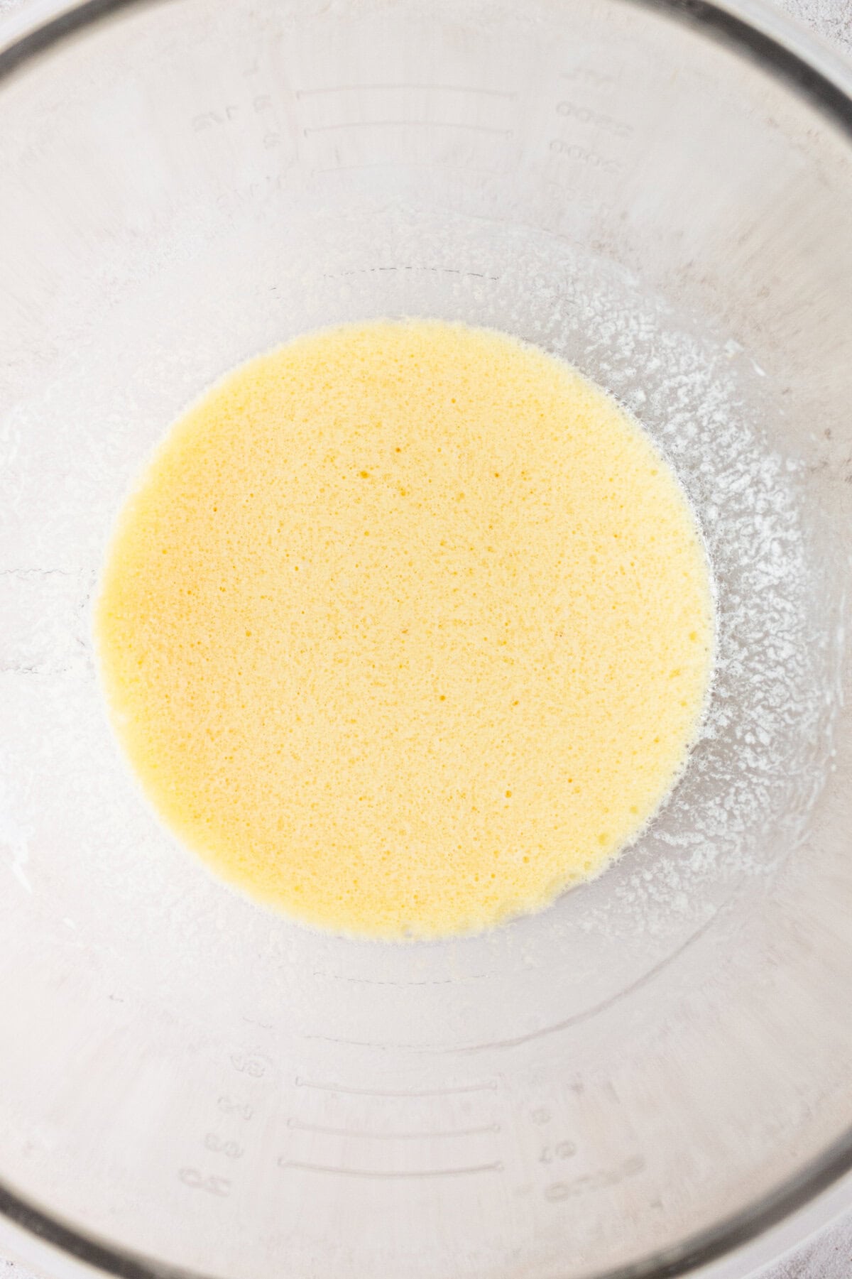Mixing wet ingredients together to make chocolate cake with vanilla frosting.