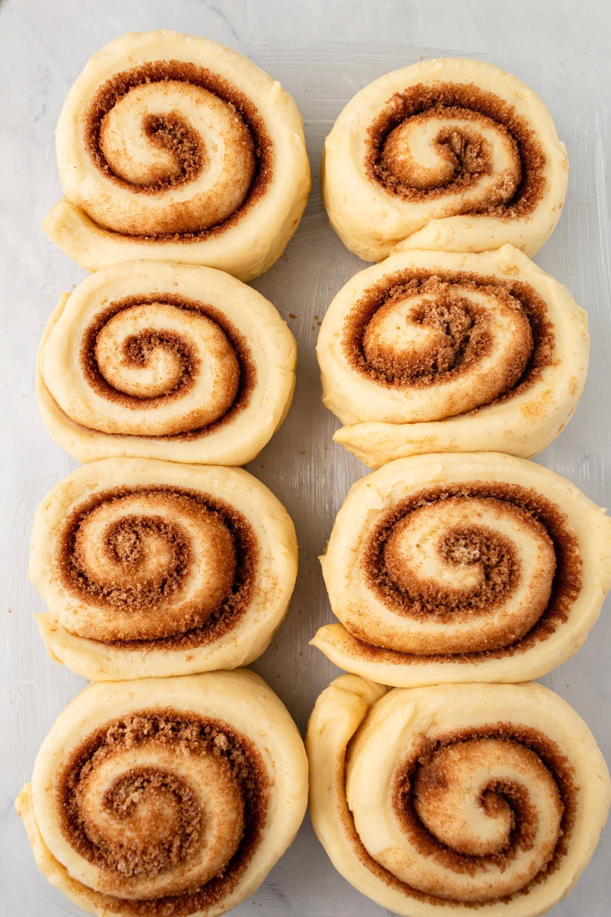 Place cinnamon rolls on baking sheet to rise for a second time.