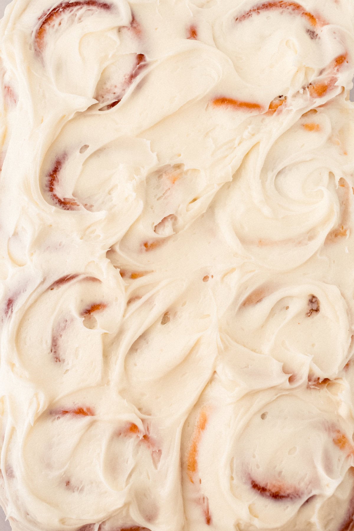 Frosted homemade cinnamon rolls with cream cheese frosting.