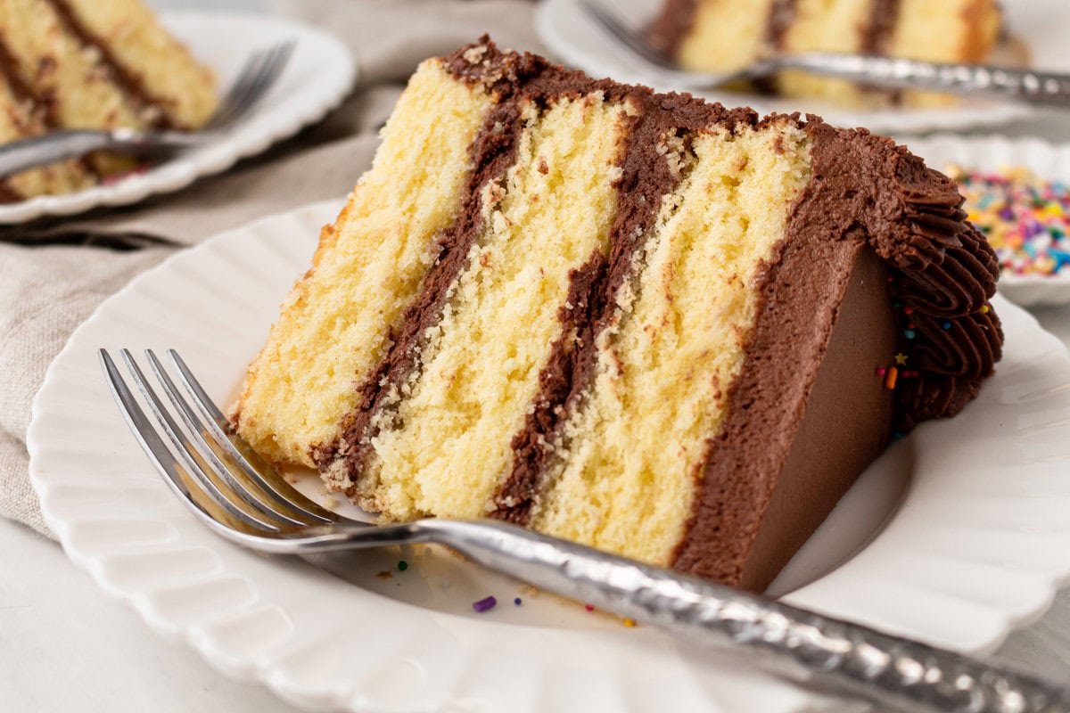 The BEST Yellow Cake Recipe with Milk Chocolate Frosting. 5-Star Rated Recipe! This golden, tender yellow cake is topped with a thick layer of creamy chocolate frosting. Thanks to a secret ingredient -- this homemade yellow cake bakes up moist, fluffy, and full of flavor every time. If you are celebrating a birthday, make sure to request this Yellow Birthday Cake with Chocolate Frosting!