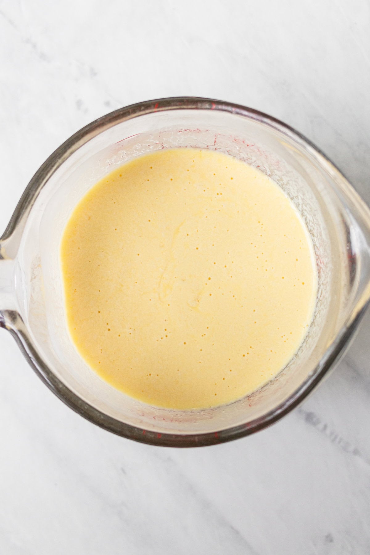 Mixing wet ingredients together to make a yellow cake.