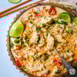 This tender Poached Coconut Milk Chicken with aromatics, creamy coconut milk, red Thai curry paste, and spices all atop rice is made in less than 30 minutes and is perfect for a weeknight dinner.