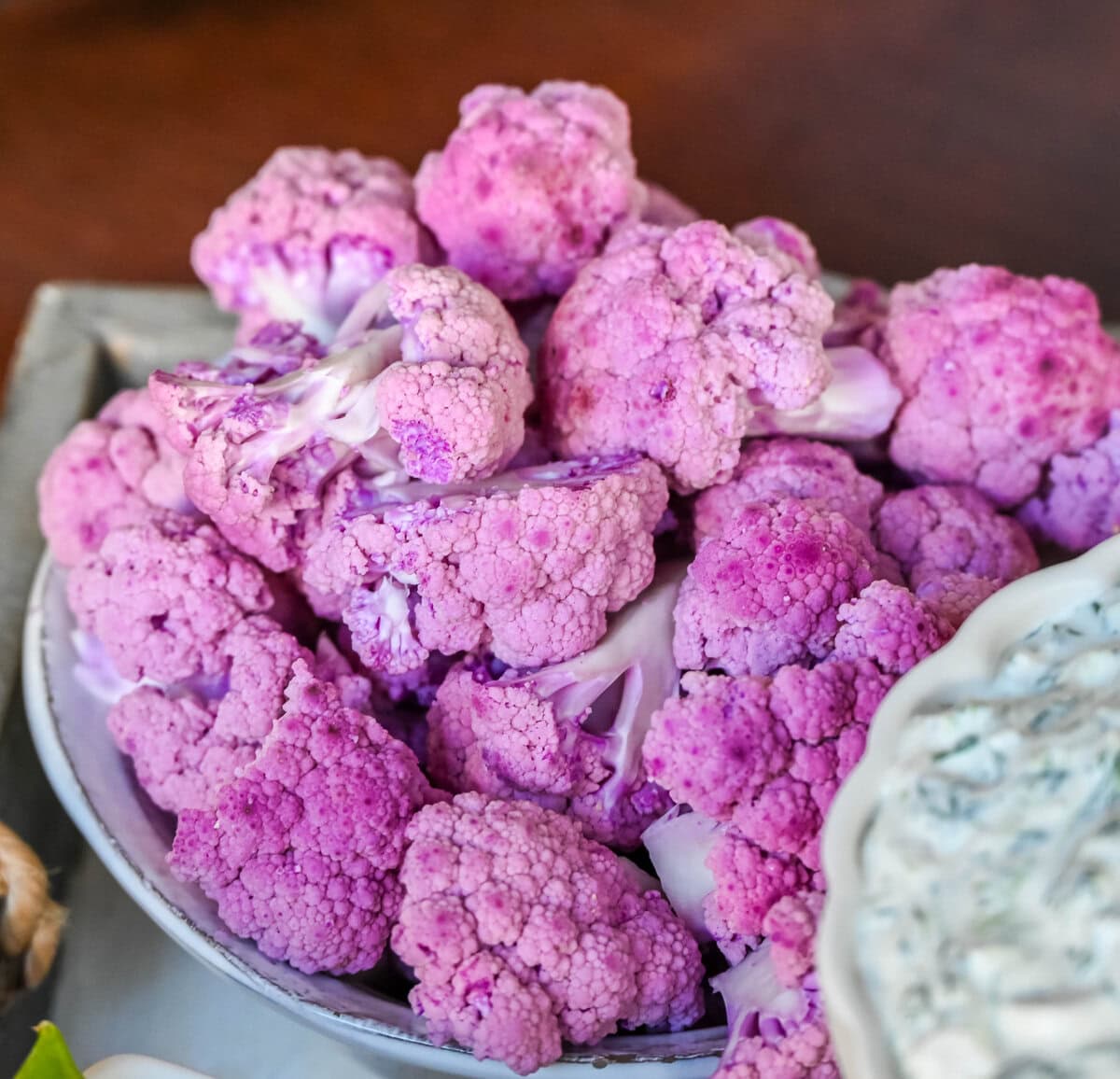 Purple cauliflower on crudite platter or vegetable board.