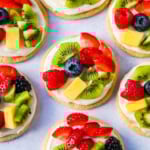 These Fruit Pizza Cookies are made with soft, chewy, buttery sugar cookies topped with a sweet cream cheese frosting and fresh fruit. These Sugar Cookie Fruit Pizzas are always a huge hit!