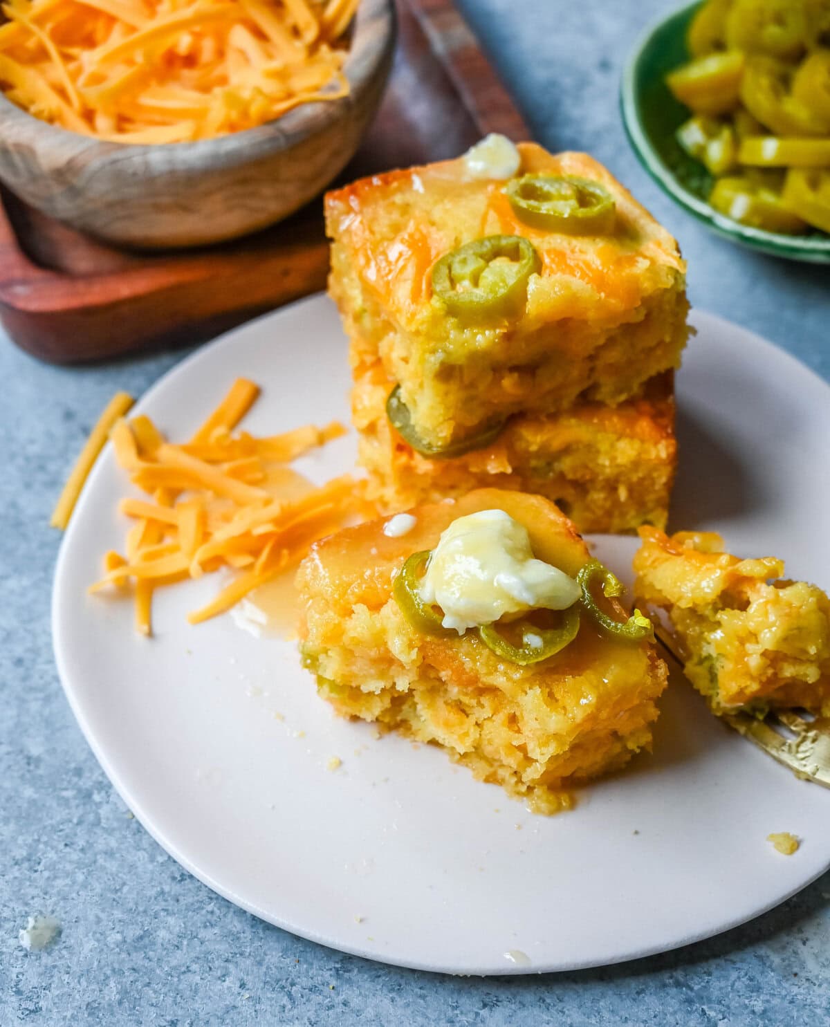 This Homemade Jalapeno Cheddar Cornbread is golden, cheesy, spicy, and just a little sweet, and is the ultimate upgrade from basic boxed cornbread. It has a moist, fluffy center amd layered with sharp cheddar cheese and jalapenos for the perfect Jalapeno Cheddar Cornbread recipe.
