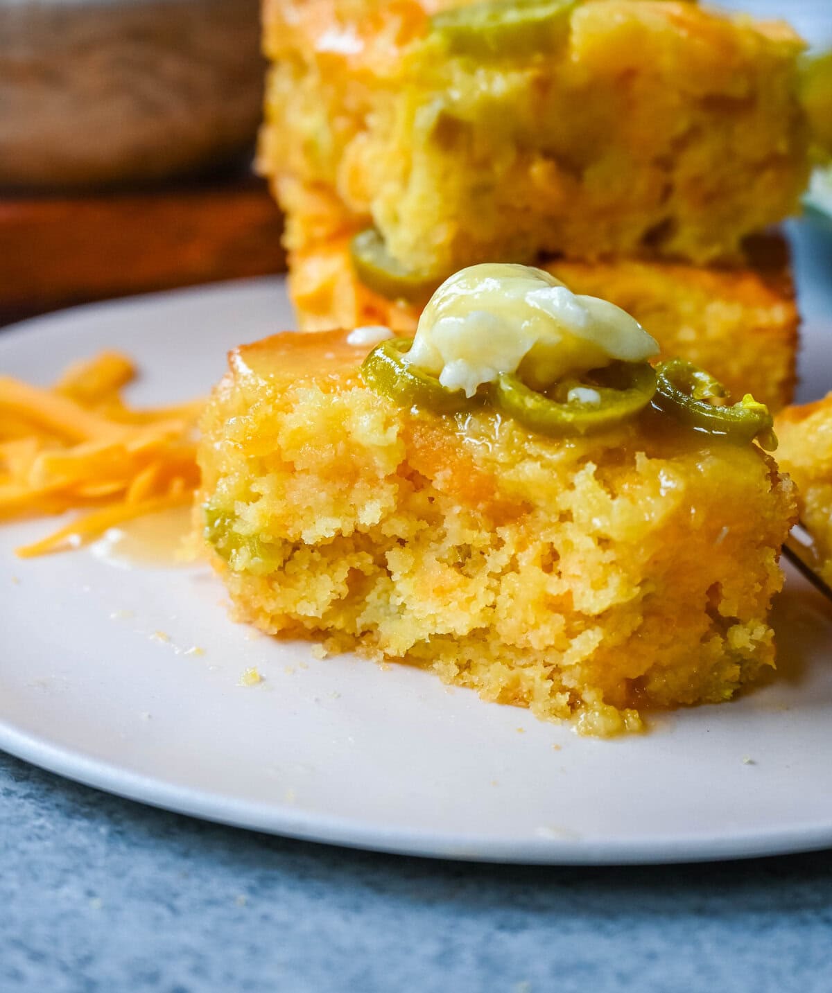 This Homemade Jalapeno Cheddar Cornbread is golden, cheesy, spicy, and just a little sweet, and is the ultimate upgrade from basic boxed cornbread. It has a moist, fluffy center amd layered with sharp cheddar cheese and jalapenos for the perfect Jalapeno Cheddar Cornbread recipe.