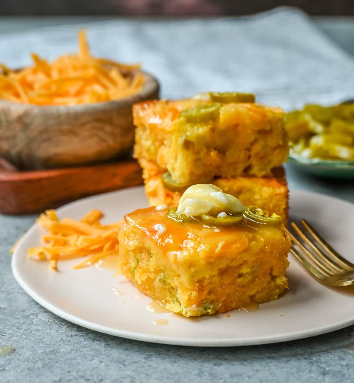 This Homemade Jalapeno Cheddar Cornbread is golden, cheesy, spicy, and just a little sweet, and is the ultimate upgrade from basic boxed cornbread. It has a moist, fluffy center amd layered with sharp cheddar cheese and jalapenos for the perfect Jalapeno Cheddar Cornbread recipe.