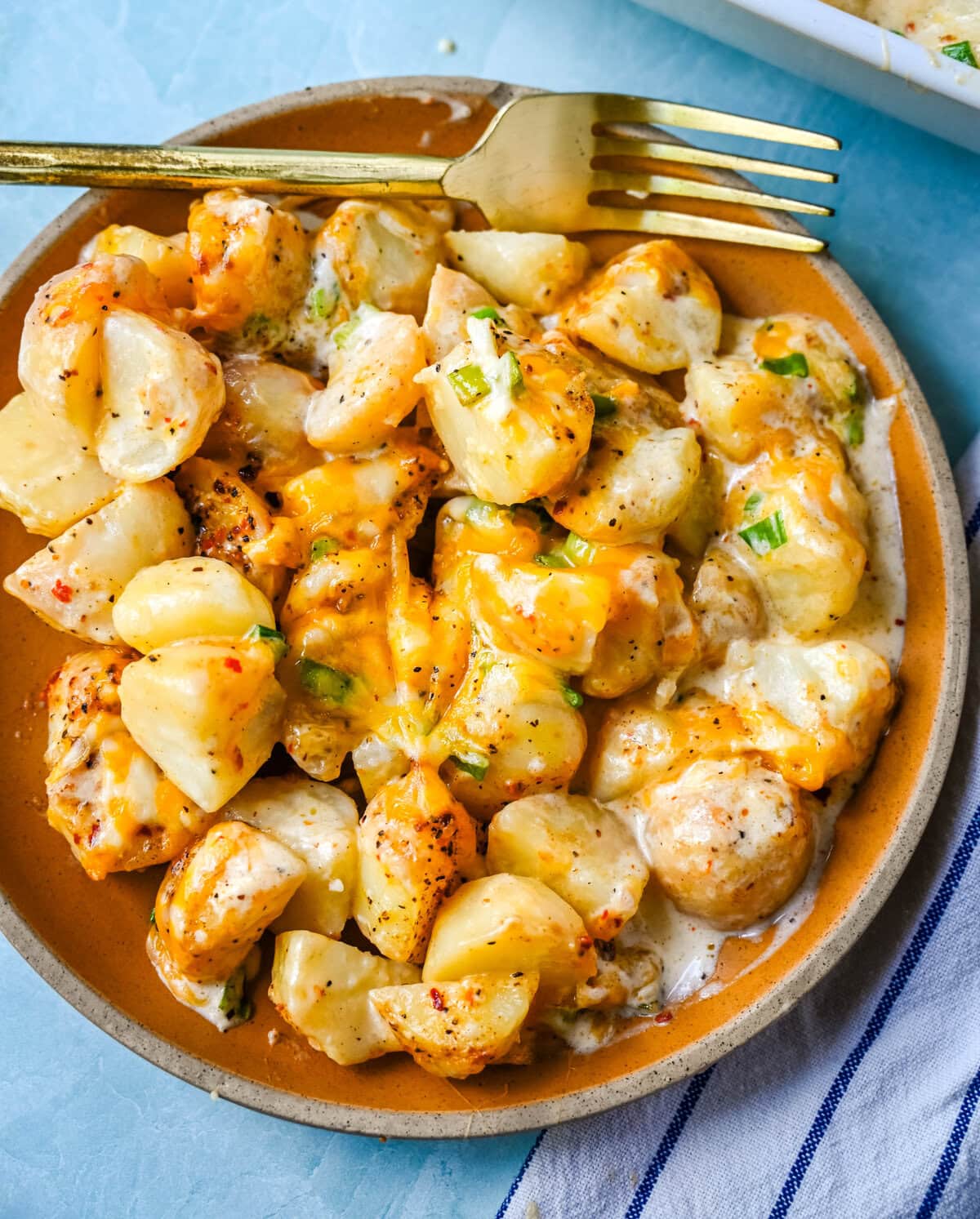 Perfect for family dinners or holiday tables, these creamy potatoes are savory, rich, and the perfect comfort food. These Kerry's Special Potatoes start with buttery, creamy yukon gold potatoes, and topped with seasoned salt and pepper, heavy cream, cheddar cheese, and sprinkled with green onions. You only need 6 ingredients to make these special potatoes.